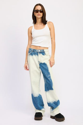 back view model in bleach tie dye high waist wide leg jeans showing white bleach abstract pattern across back leg panels