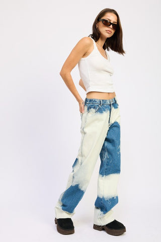 detail close up bleach tie dye high waist jeans showing texture of cotton denim with hand-bleached white abstract pattern