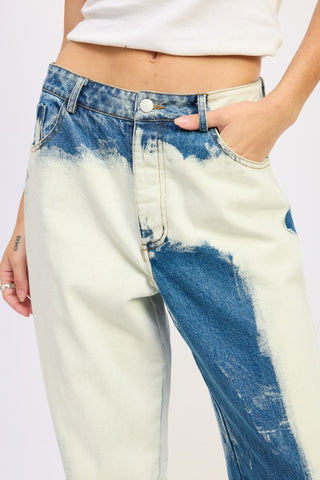 three quarter view bleach tie dye high waist wide leg jeans showing abstract dye pattern and relaxed wide leg fit