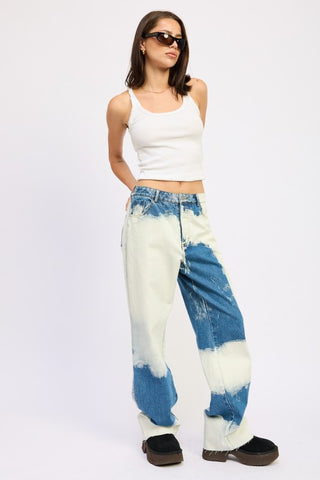 side profile bleach tie dye wide leg jeans showing high waist rise relaxed silhouette and contrast bleach pattern