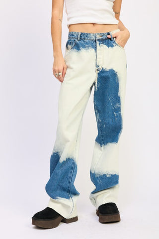 close up waist and leg detail bleach tie dye wide leg jeans showing bold white irregular bleach pattern on indigo cotton denim