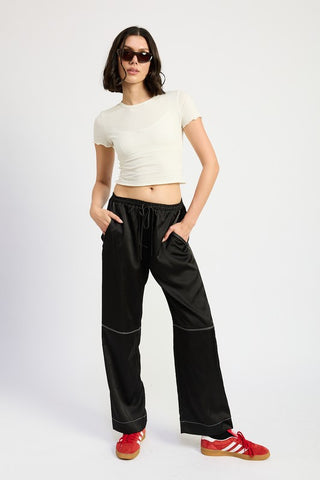 Margaux black satin wide leg pants with white contrast topstitching at seams, drawstring waist, full length front view