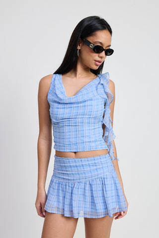 side view blue plaid cowl neck crop top showing cascade ruffle panel profile and crop length above navel