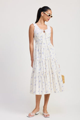 close up skirt detail eyelet midi dress cotton showing periwinkle blue rose ditsy print and tiered hem