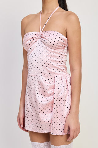 close up bust detail pink polka dot halter mini dress showing gathered center twist bust and halter neck tie
