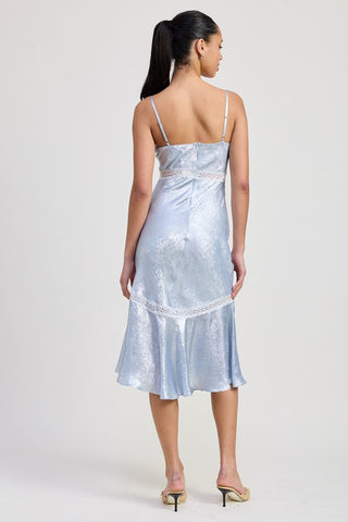detail shot fishtail hem with white lace trim on baby blue metallic lace trim midi slip dress