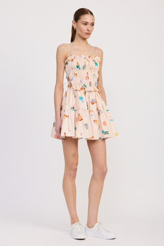 close up fabric detail cotton poplin mini dress showing illustrated sunbathers umbrellas and beach accessories novelty print
