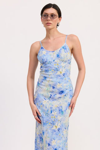 back view blue floral satin slip midi dress showing V-back spaghetti strap construction and watercolor print from behind