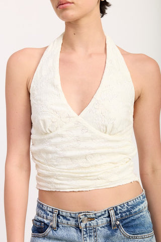 close up cream floral stretch lace halter crop top showing raised botanical lace motif and horizontal ruching across torso