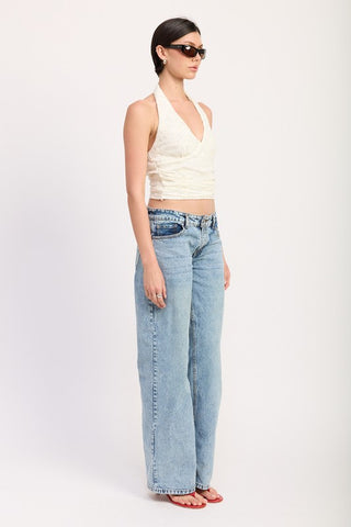 close up detail raised floral lace texture on cream stretch lace halter crop top showing botanical pattern
