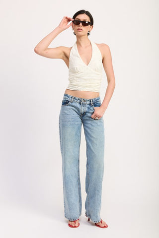 back view cream lace halter top showing open back and halter tie at neck above wide leg denim