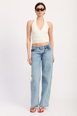 full length front view cream lace halter top with wide leg jeans and red flat sandals showing full outfit proportion