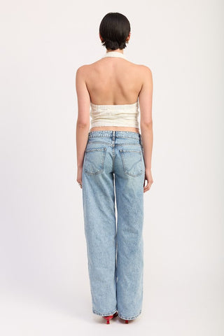 model in cream lace halter top full portrait view showing V neckline and open shoulder silhouette with sunglasses