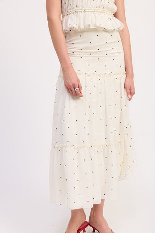 close up waist and skirt detail cream polka dot tiered midi skirt showing smocked waistband and two tiers with ruffle hem