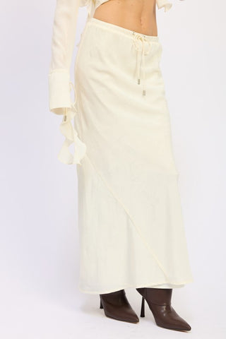 back view ivory satin maxi skirt showing slim fitted silhouette and floor length from behind