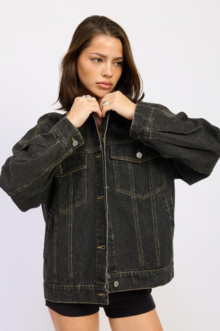 back view black washed oversized denim jacket showing drop shoulder construction and hip length from behind