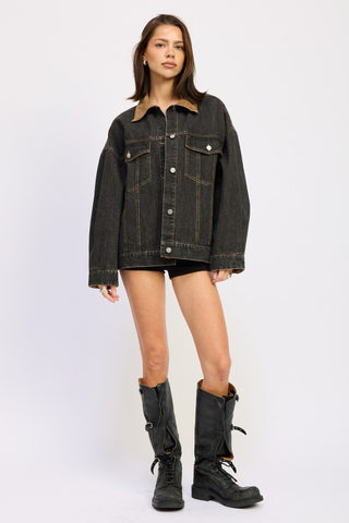 full length model in black mixed media denim jacket showing drop shoulder fit and hip length