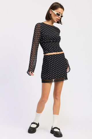 back view black white polka dot fitted mini skirt showing lace scalloped hem from behind