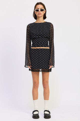 back view black polka dot sheer long sleeve crop top showing open back tie closure and bell sleeve from behind