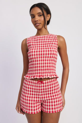 side profile blue gingham smocked top showing fitted smocked body and sleeveless crop silhouette
