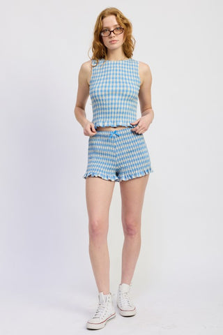 full length model in blue gingham smocked crop top showing crop length and fitted smocked body