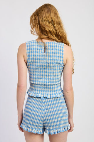 three-quarter view Poppy blue cream gingham smocked shorts showing lettuce hem edge and smocking texture