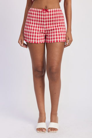 side profile blue gingham smocked shorts showing mid-thigh length and fitted smocked body