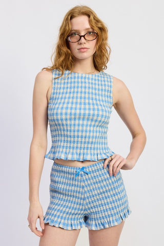 full length model in blue gingham smocked shorts showing mid-thigh length and fitted smocked body