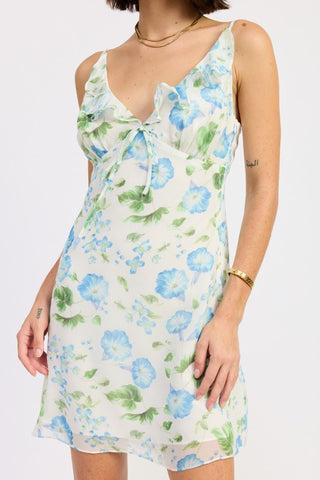 close-up bodice detail ivory blue chiffon dress showing ruffle neckline, front tie bow and watercolor floral print