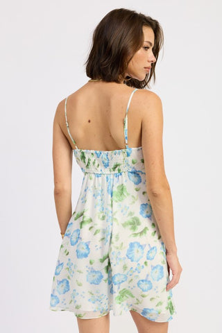 portrait close-up white chiffon V-neck mini dress with blue watercolor morning glory floral and ruffle chest detail