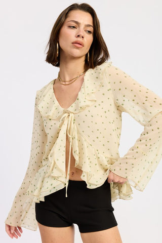close-up of ruffle trim flyaway front panels on ivory sage green polka dot butterfly blouse