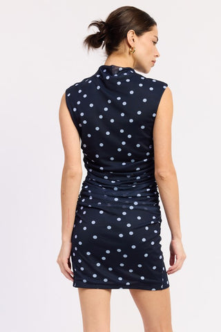 portrait close-up model in navy polka dot mesh mock neck mini dress showing stand up collar and white dot pattern