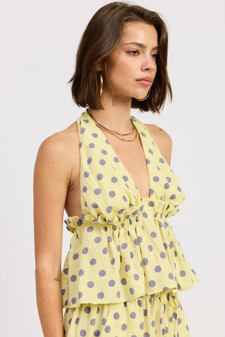side profile yellow gray polka dot ruffle peplum halter top showing open back tie detail