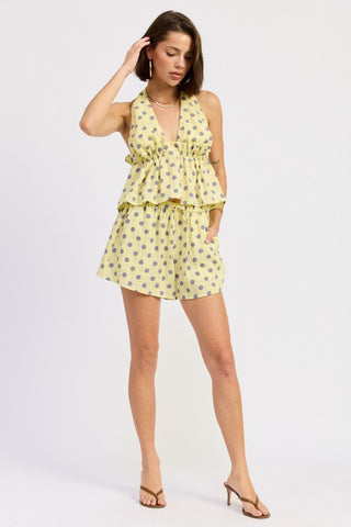 full length model in yellow gray polka dot ruffle peplum halter top with matching shorts and sandals