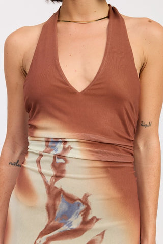 close-up bodice detail terracotta halter maxi dress showing solid terracotta transition to abstract botanical print at hip