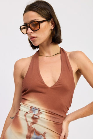 three-quarter view Rio terracotta print halter maxi dress showing abstract botanical print and stretch mesh floor length