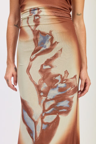 full length model in terracotta abstract print boho halter maxi dress showing floor length and stretch mesh construction