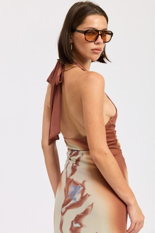 side profile model in terracotta print boho halter maxi dress showing flowing stretch mesh skirt
