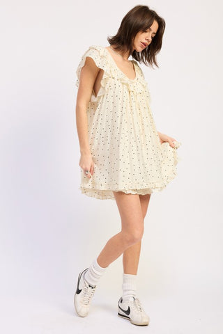detail shot ruffle flutter sleeve and polka dot print on babydoll romper