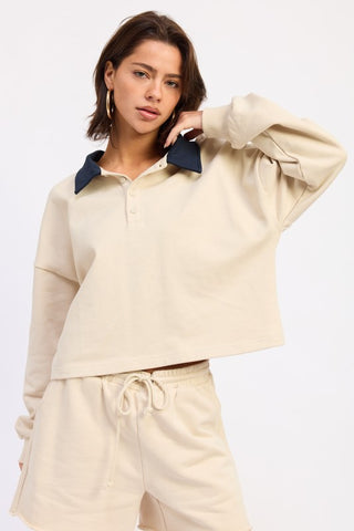 back view cream polo crop top showing standard back, long sleeves and ribbed cuff detail