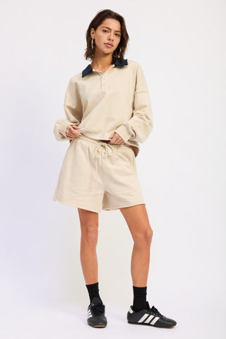 full length model in cream contrast collar polo crop top showing slightly cropped length and French terry fabric