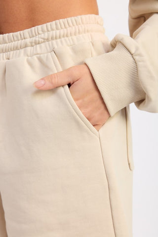 close-up waist detail cream French terry shorts showing drawstring and fabric texture