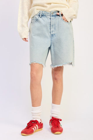 back view light wash distressed bermuda denim shorts showing back pockets and frayed hem above knee from behind