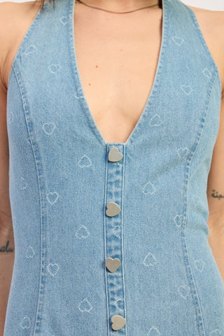 back view denim halter mini dress showing open halter back and laser heart engraved light wash denim fabric