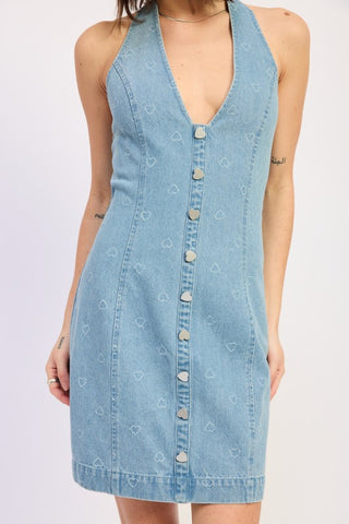 close up heart snap buttons on denim halter mini dress showing heart shaped metal hardware and laser engraved heart fabric detail