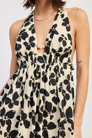 front view ivory cotton halter dress with large graphic black flower print and deep V halter neckline