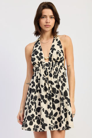 Wren graphic print cotton halter dress in ivory black with bold abstract petal shapes, cinched elastic waist and wooden bead accent