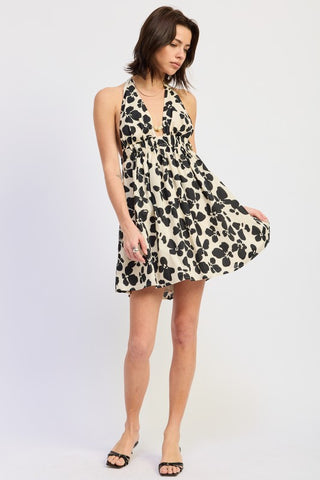 side view cinched waist mini halter dress showing A-line flare and fabric movement, graphic black floral on ivory