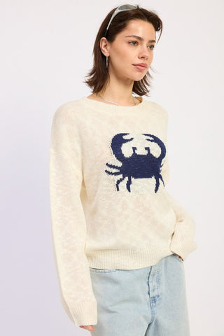 detail shot navy blue crab intarsia motif on cream slub knit sweater showing chest scale and intarsia knit construction