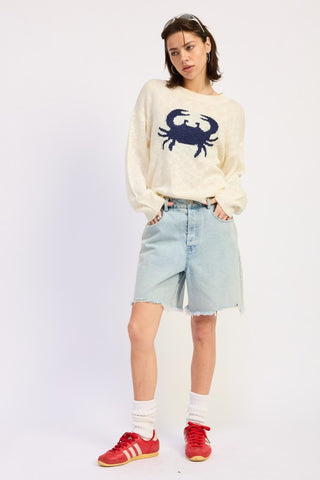 side view cream navy crab intarsia graphic knit sweater showing boxy silhouette and slub knit texture from side